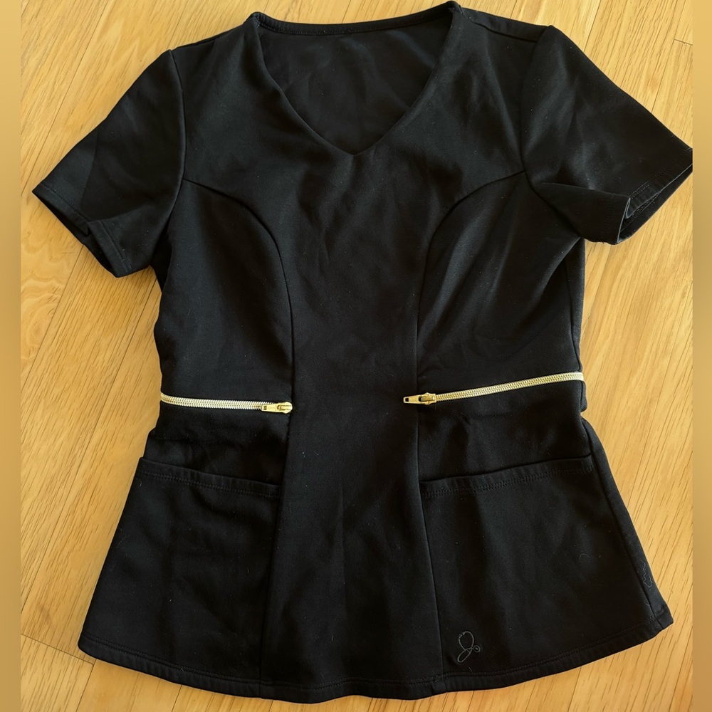 Black Jaanuu Scrub top with gold zipper accents